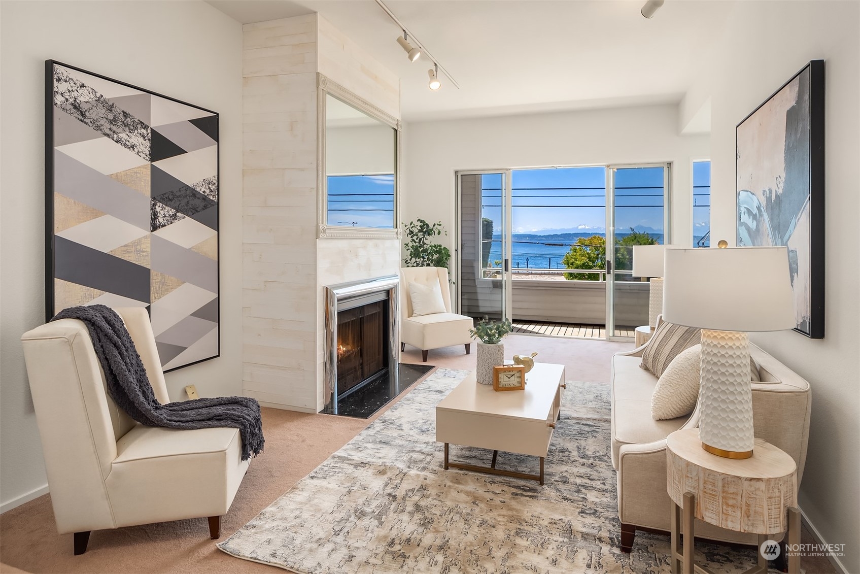 a living room with furniture a fireplace and a large window