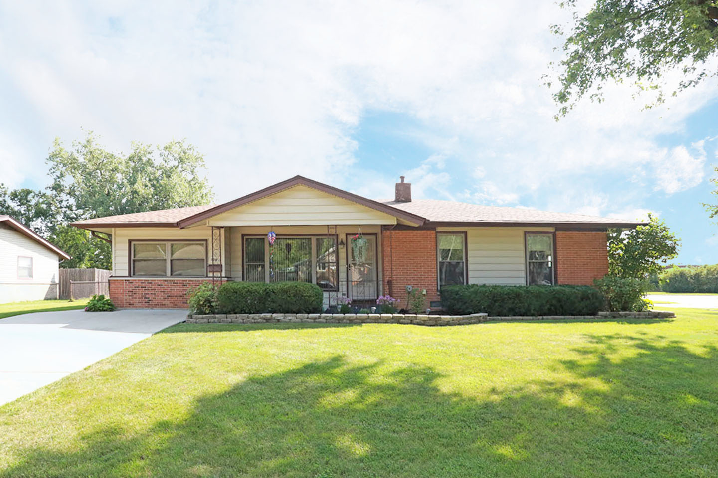 a front view of house with yard and trees around