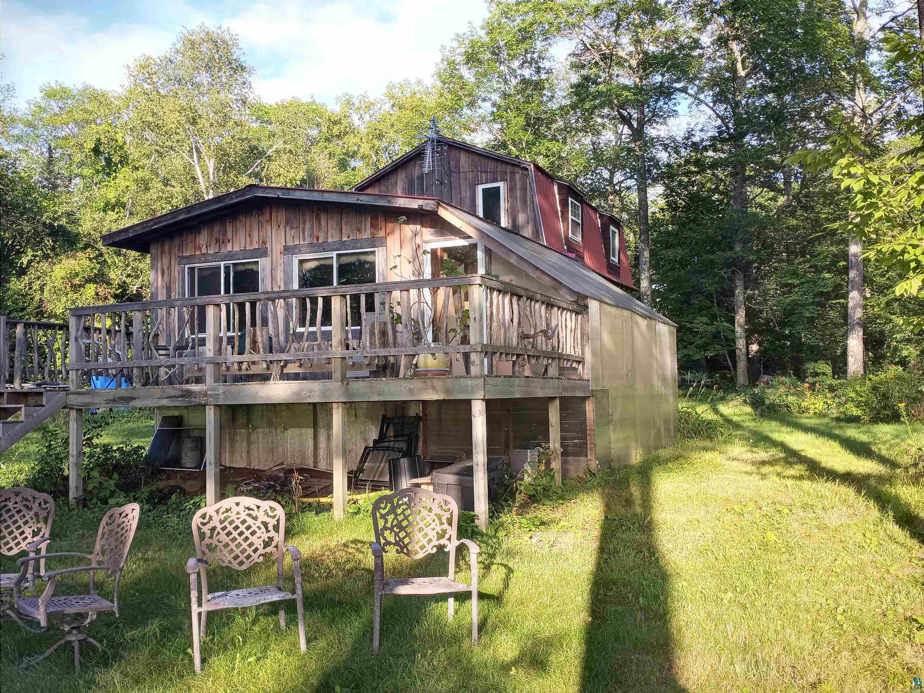 Back of property featuring a yard and a deck