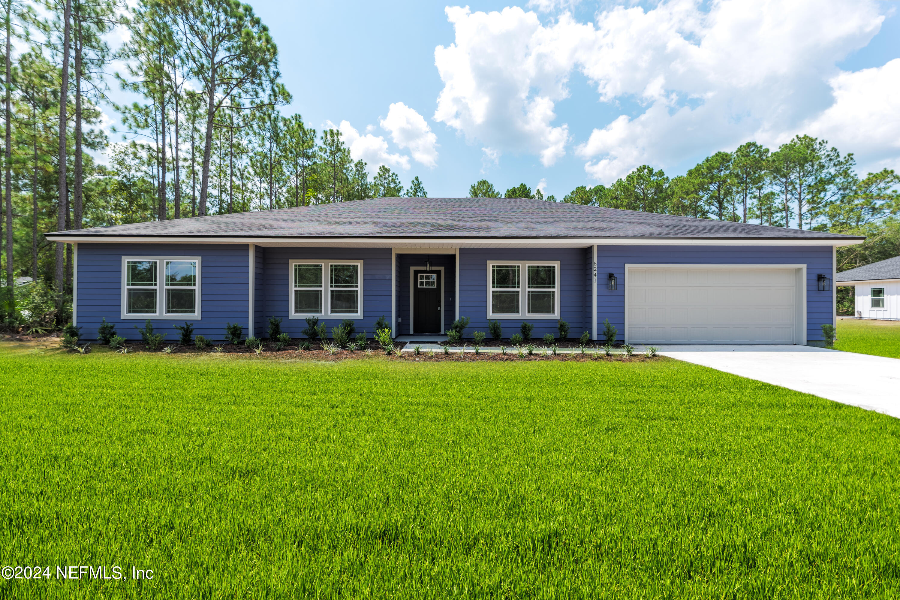 a view of a house with a backyard