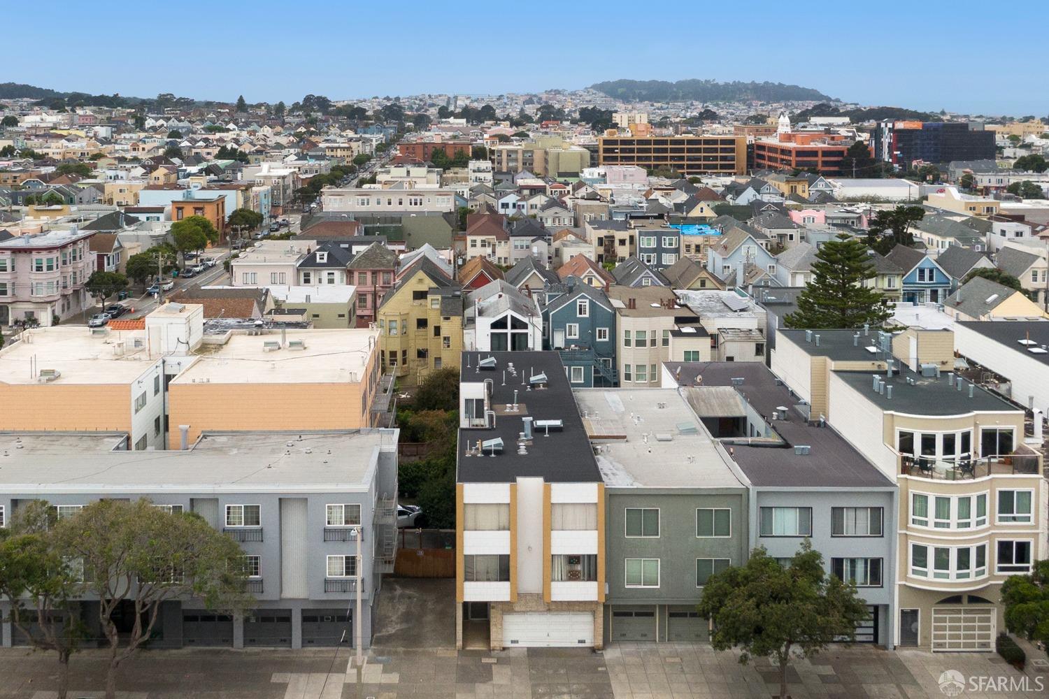 an aerial view of residential houses with outdoor space and street view