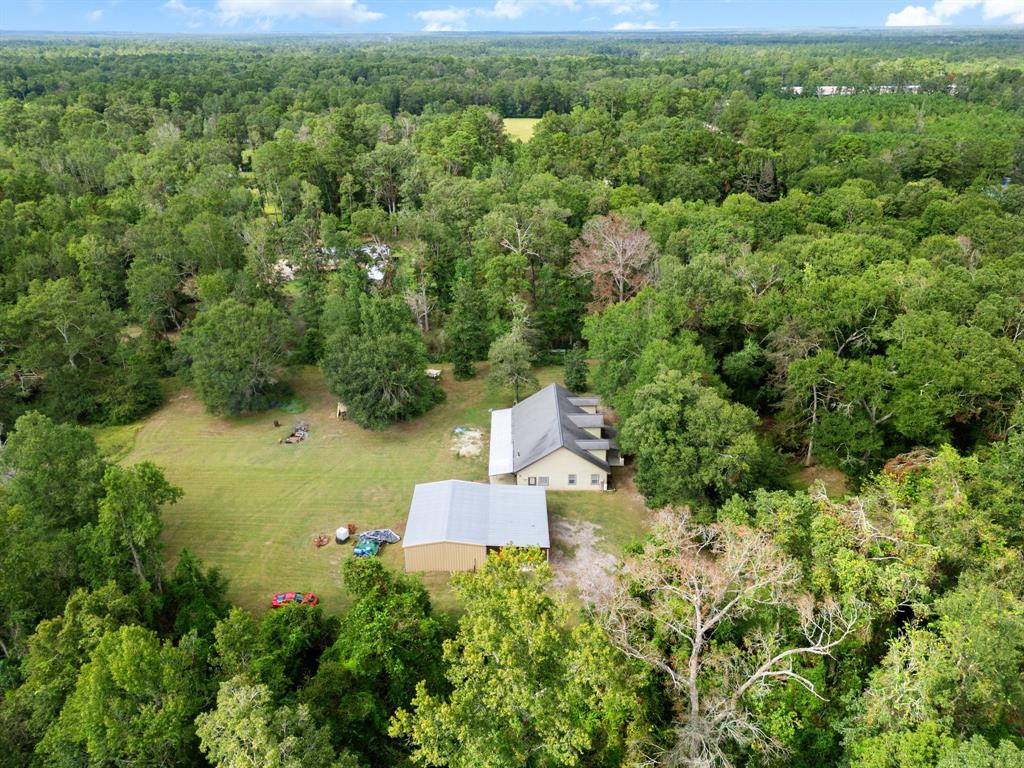 an aerial view of a house with a yard