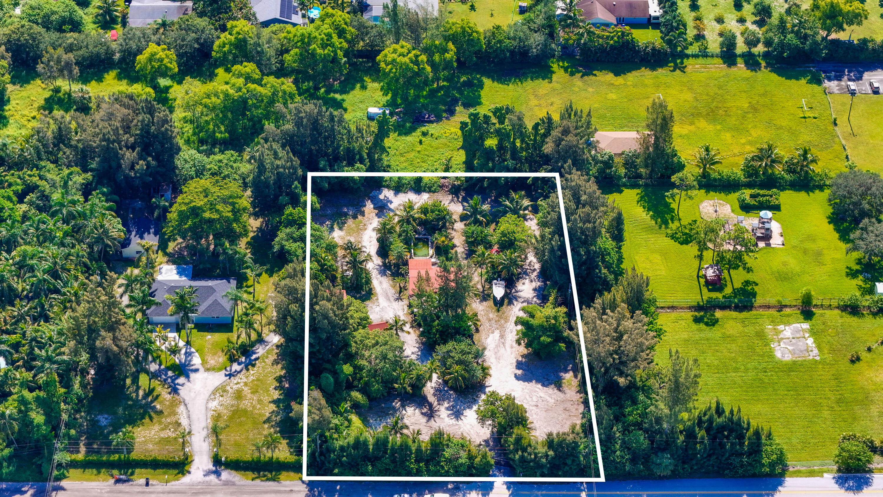 an aerial view of ocean with residential house outdoor space and swimming pool