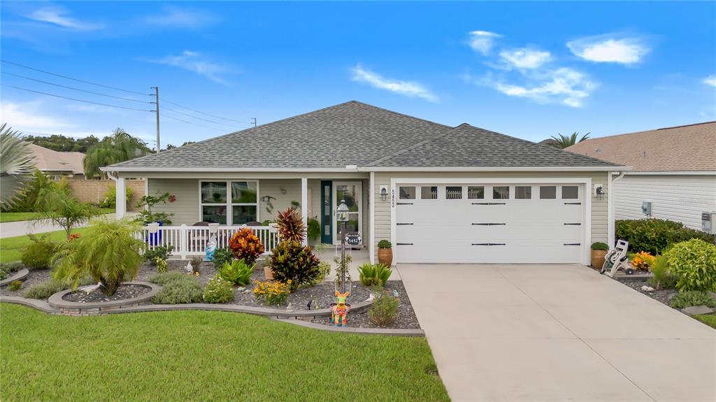 a front view of a house with a garden and plants