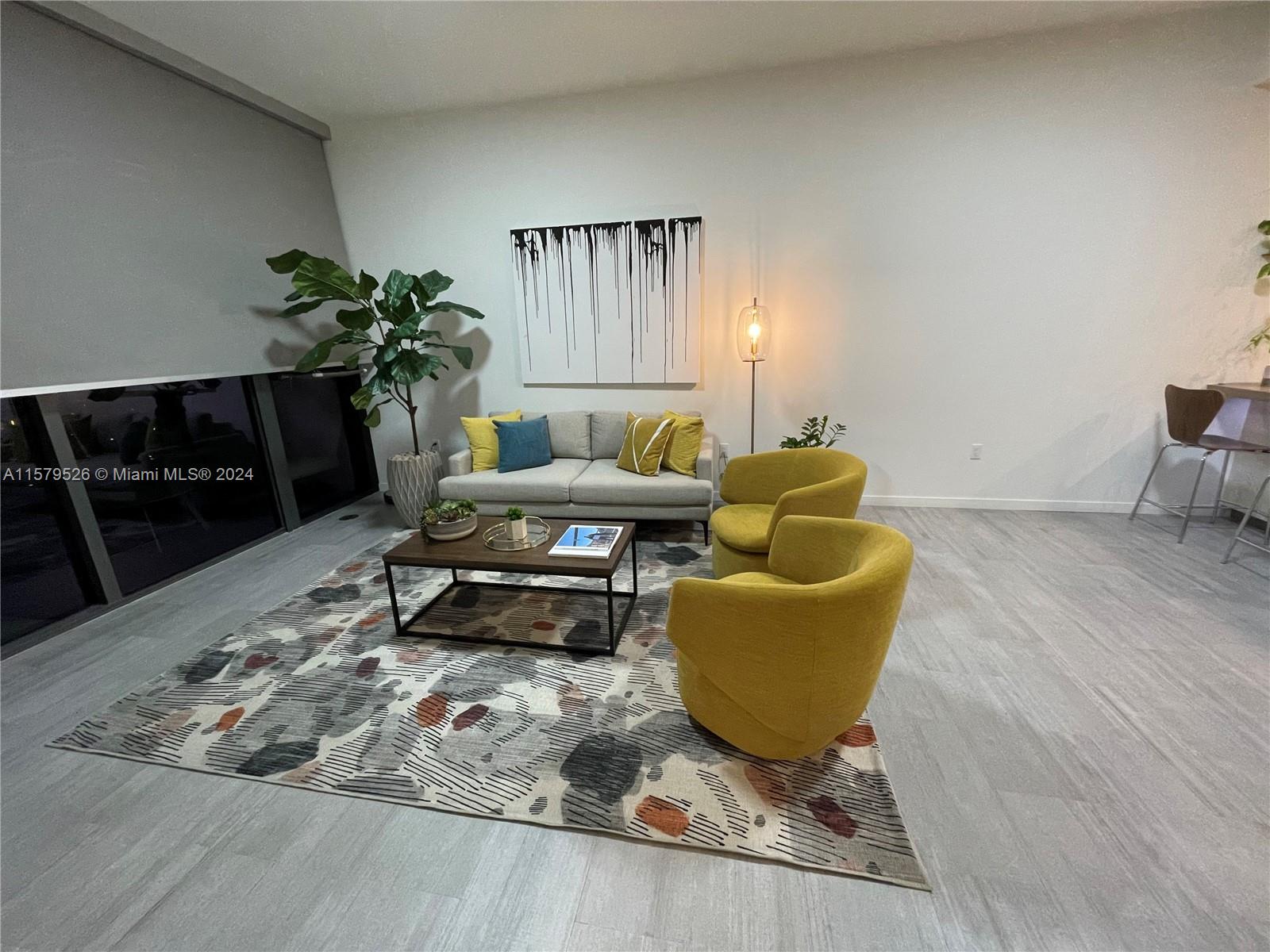 a living room with furniture and a potted plant