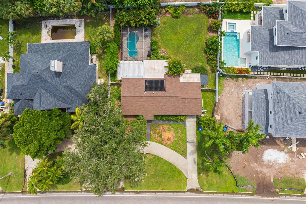 an aerial view of a house with a yard basket ball court and outdoor seating