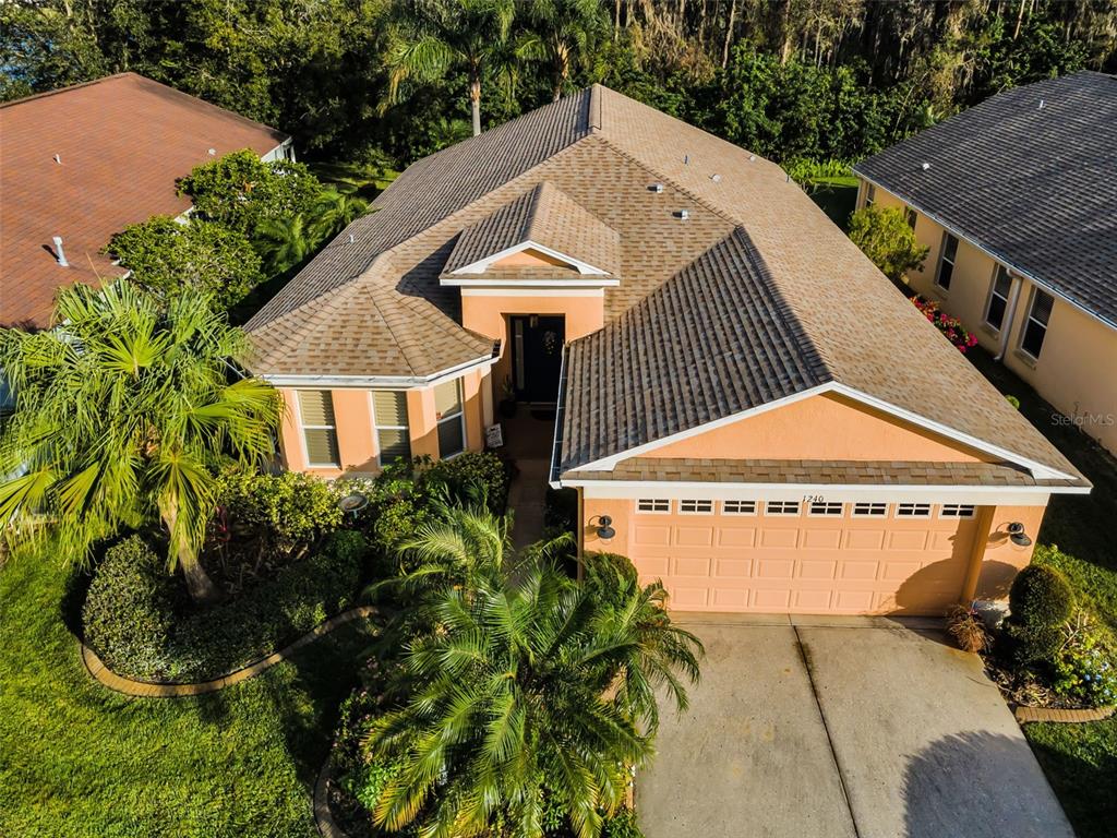 a aerial view of a house with a yard and potted plants