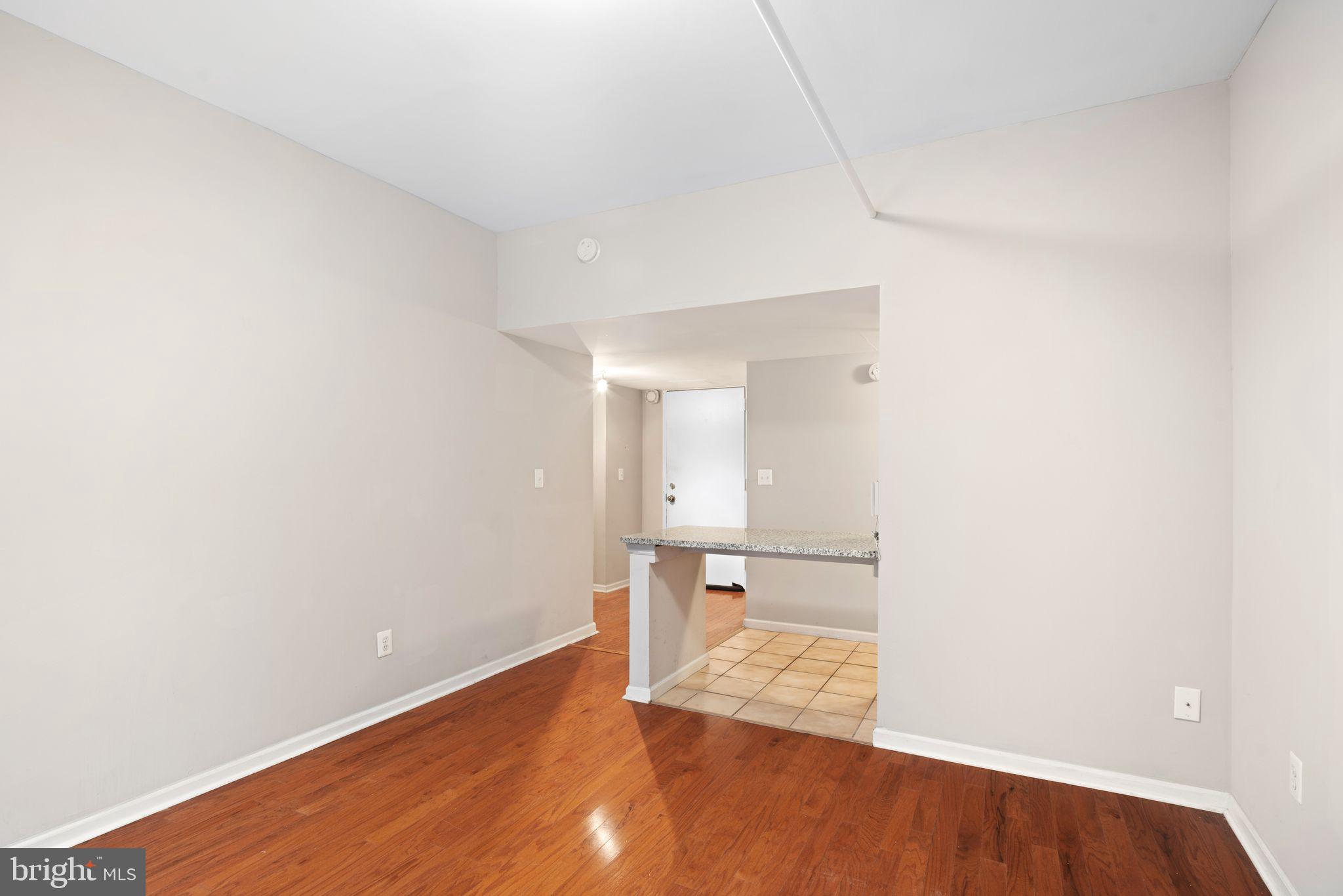 a view of a room with wooden floor and a sink