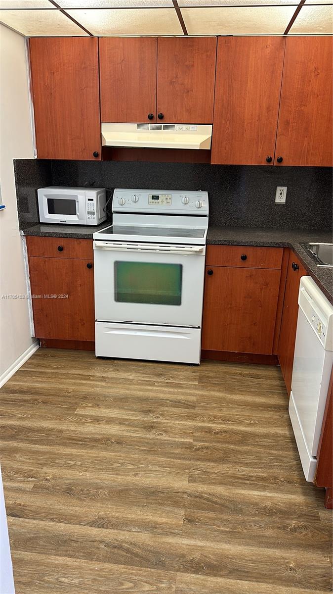 a kitchen with a stove and a microwave