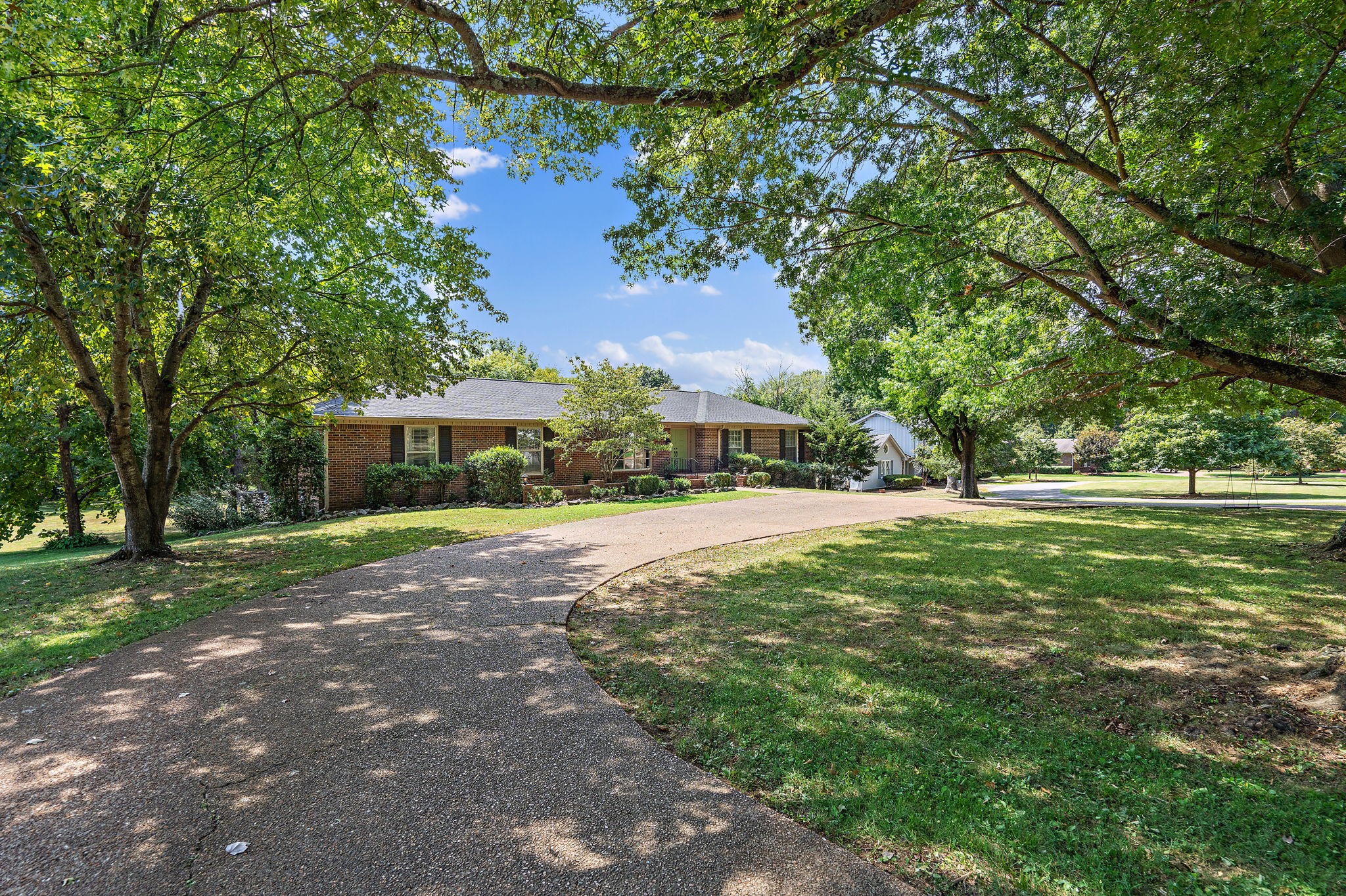 Mature trees surround this well-loved River Oaks home.