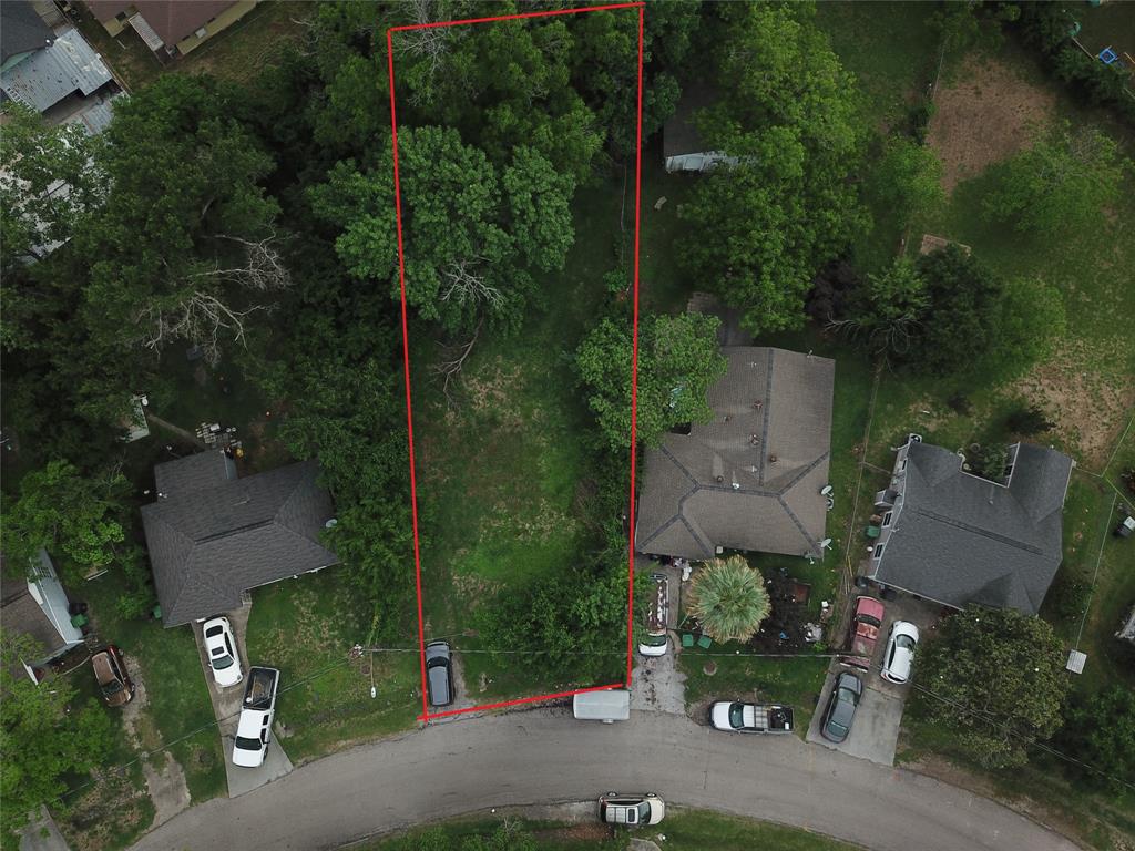 an aerial view of a house with a yard and garden