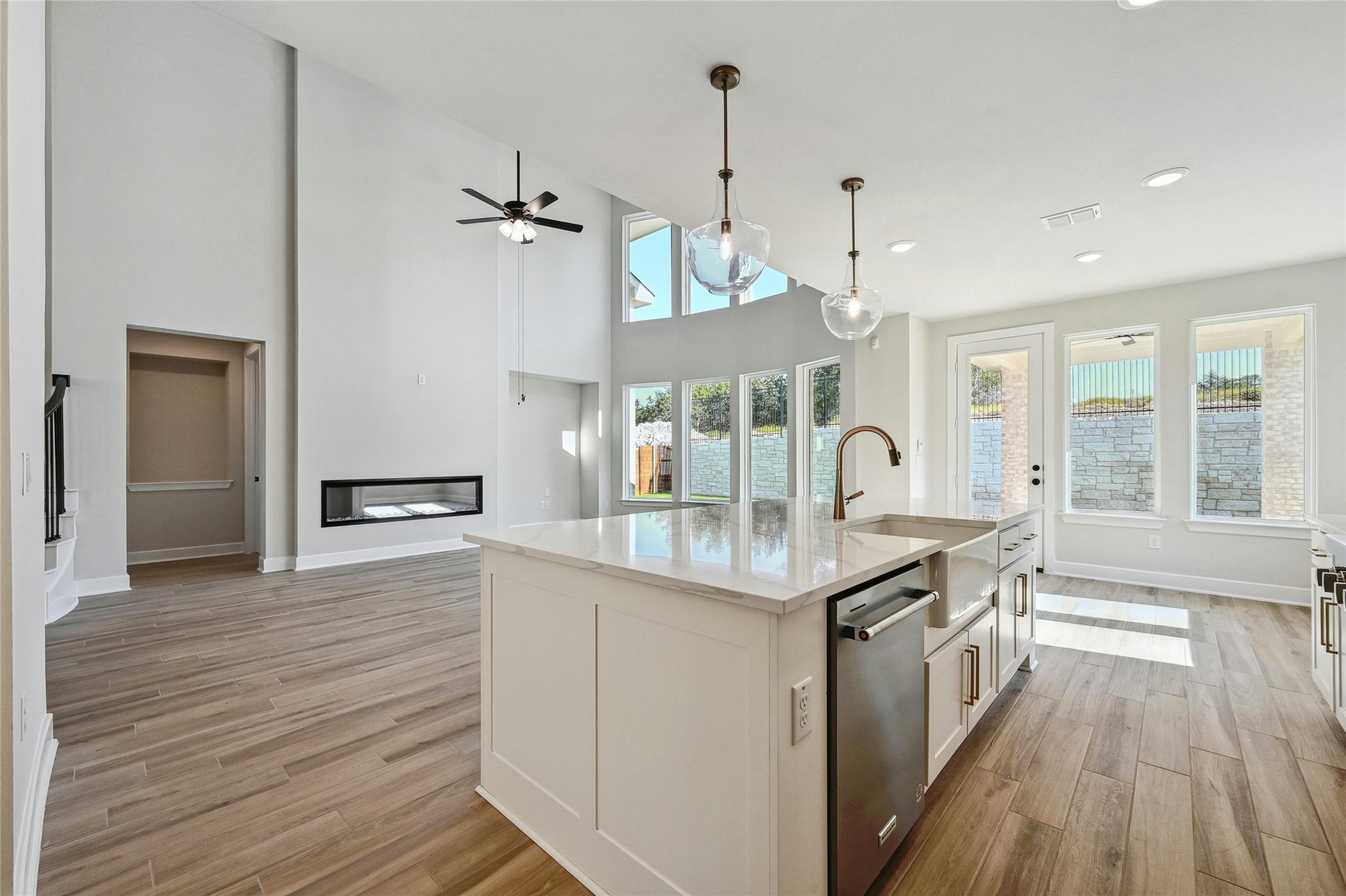 a kitchen with granite countertop a sink cabinets and wooden floor