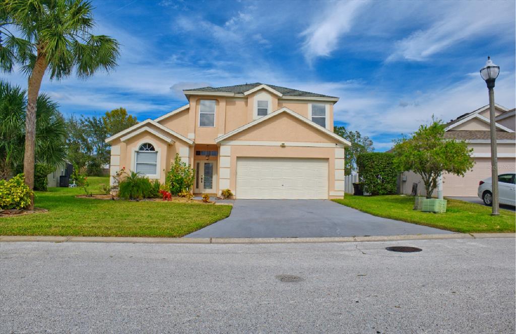 a front view of a house with a yard and garage