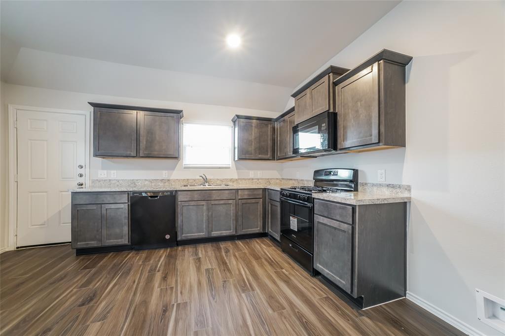 a kitchen with a sink stove and microwave