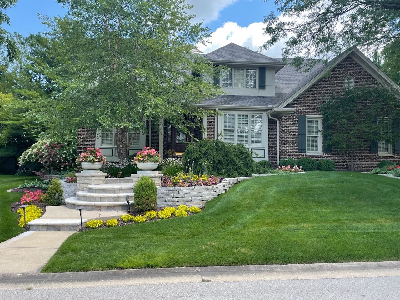 a front view of house with yard and green space