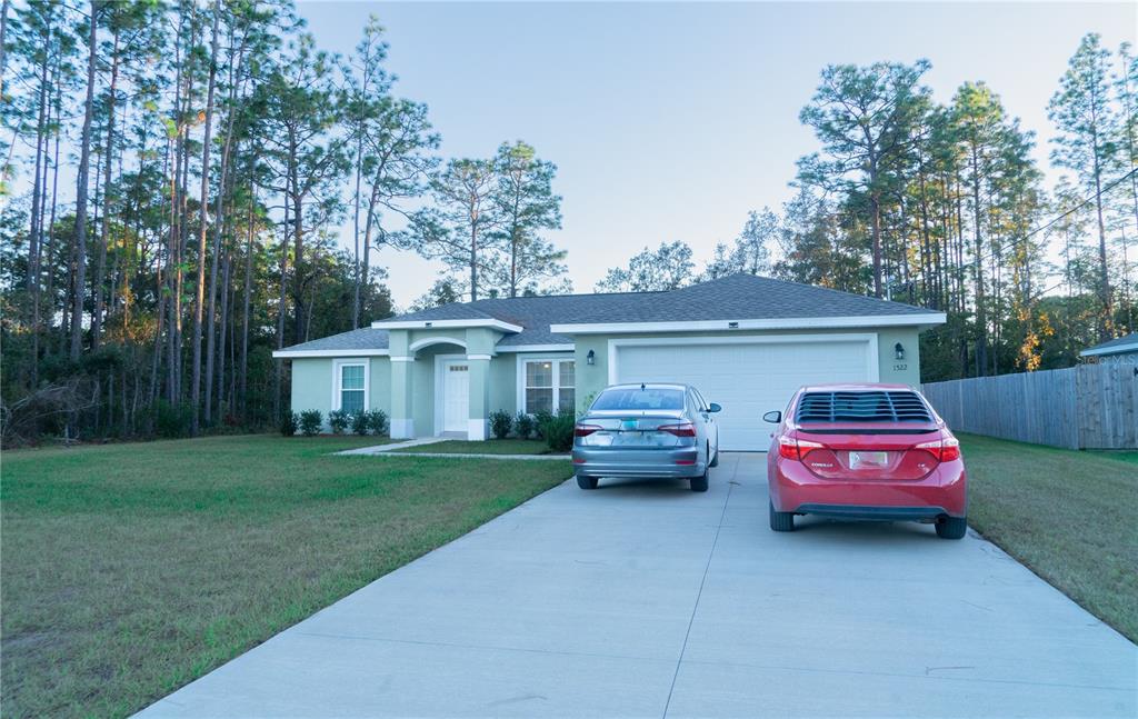 a front view of a house with a garden