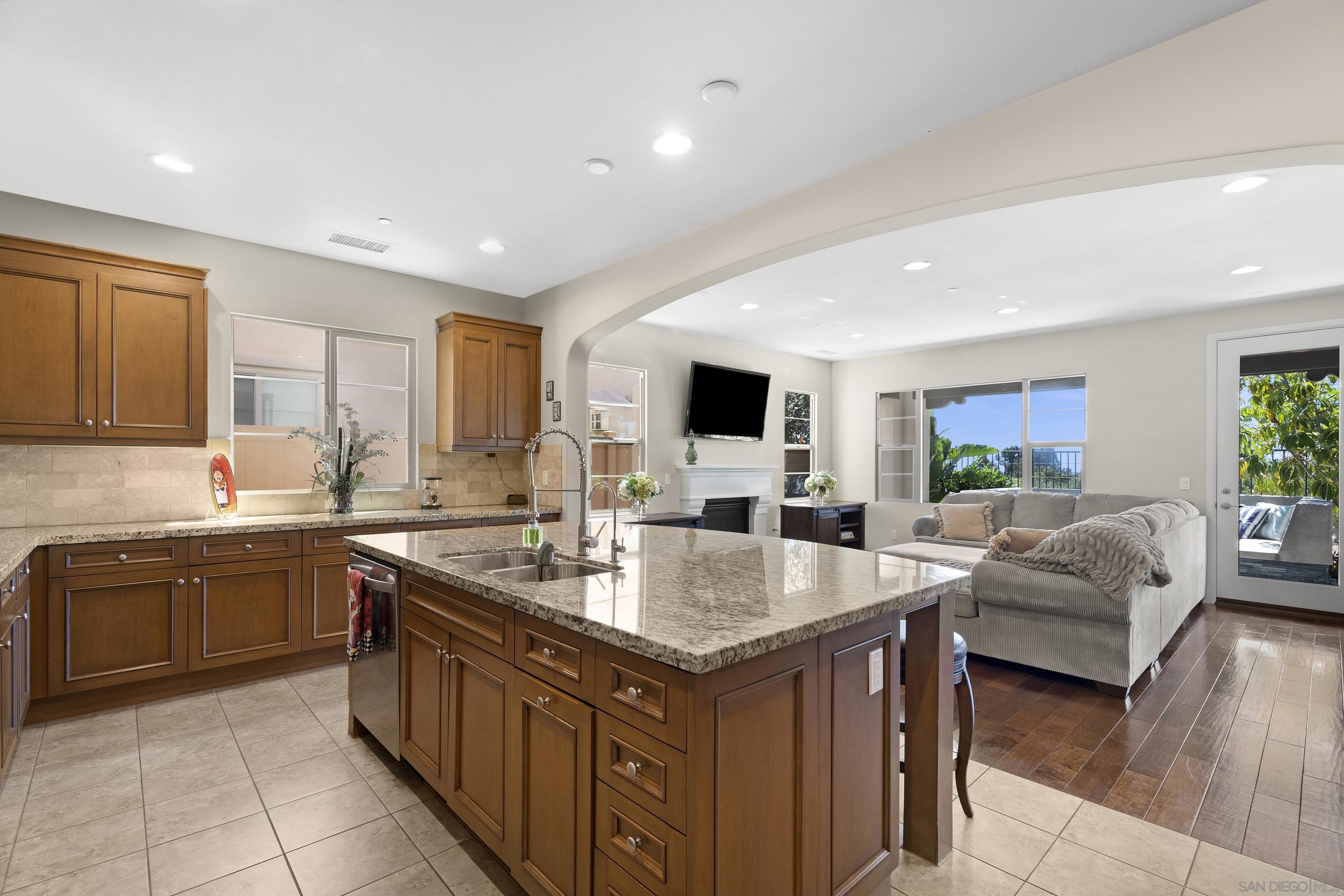 a large kitchen with stainless steel appliances granite countertop a lot of counter space sink and cabinets