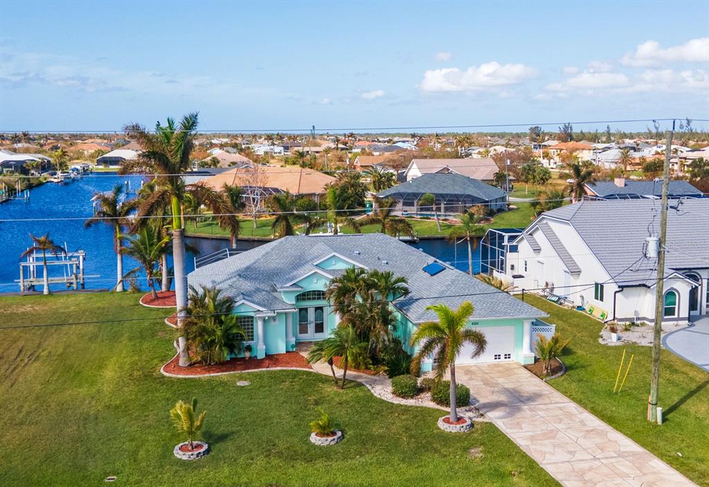 an aerial view of multiple houses with a swimming pool