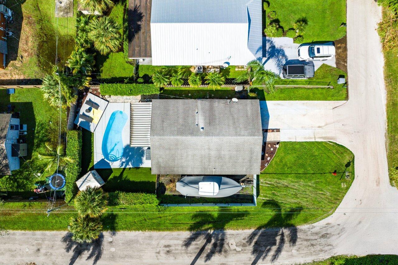 an aerial view of a house with a garden and trees