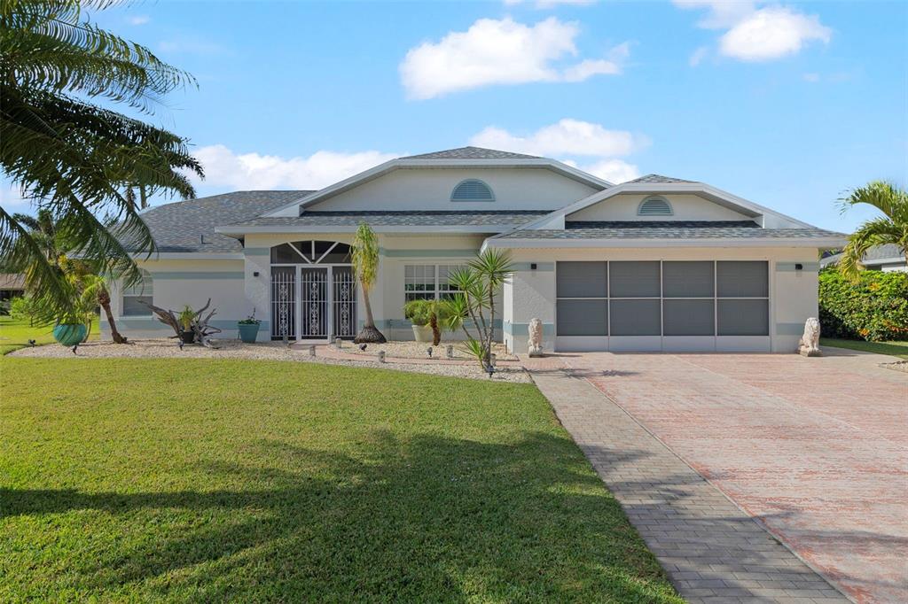 a front view of a house with a garden and patio