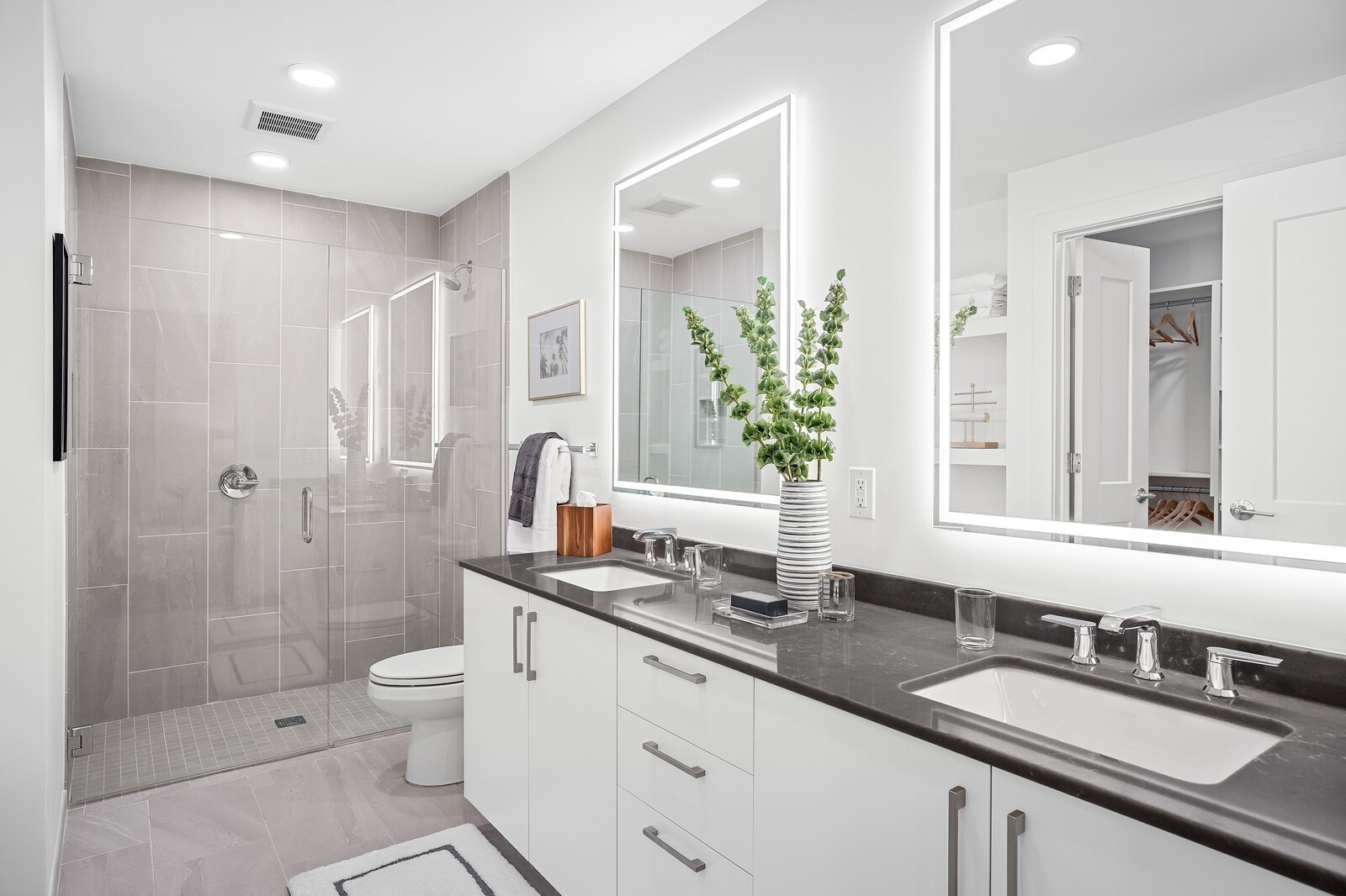 Cool Finish Package bathroom featuring facelit mirrors and a curbless walk-in shower | Photo from our Furnished B2 Model