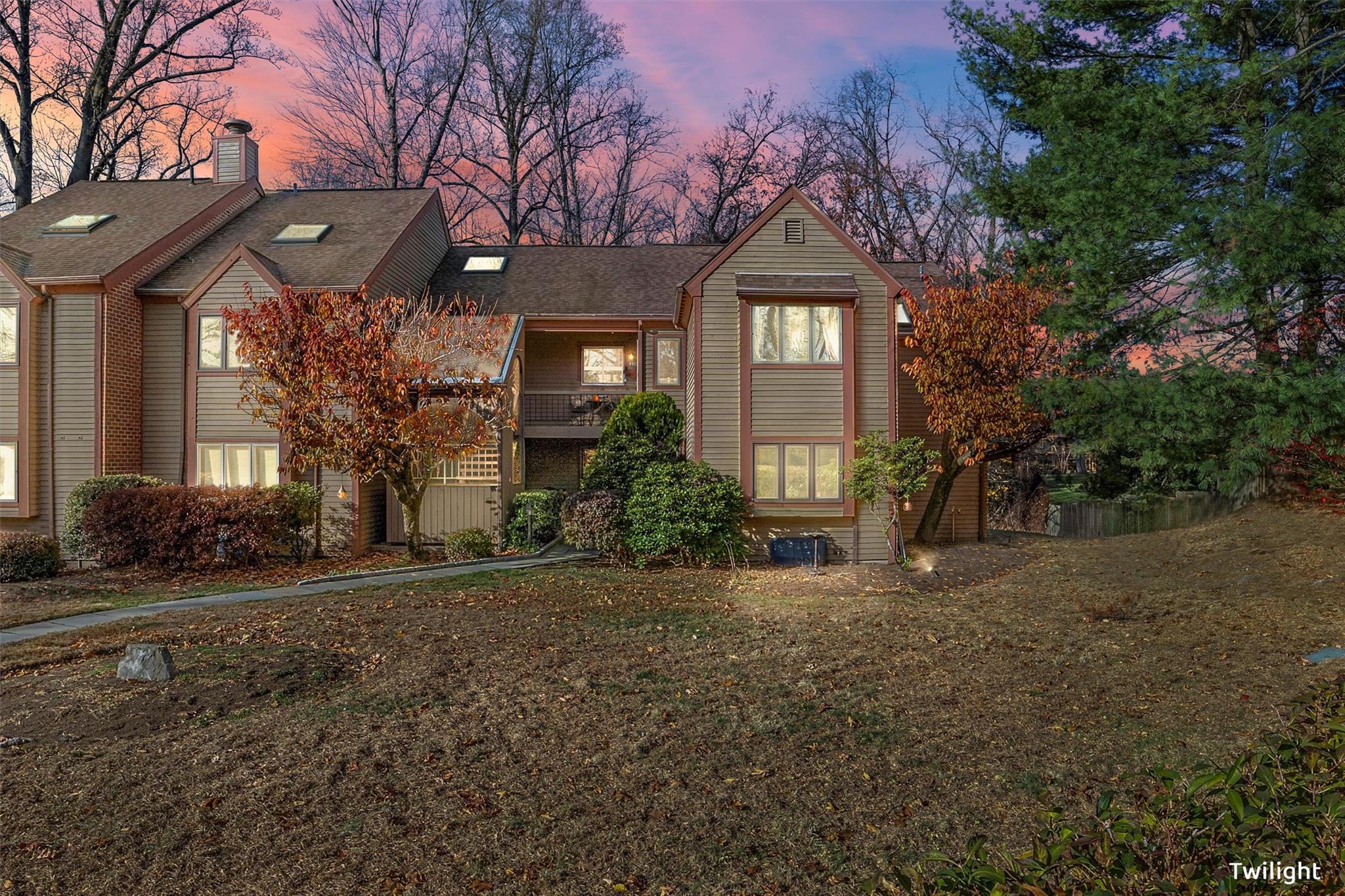 a front view of a house with a garden