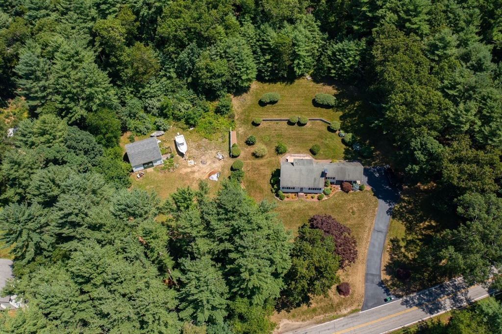 an aerial view of a house with a yard