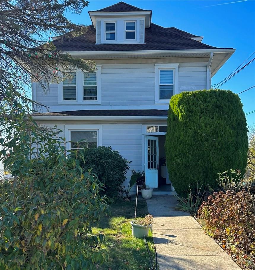 a front view of a house with garden