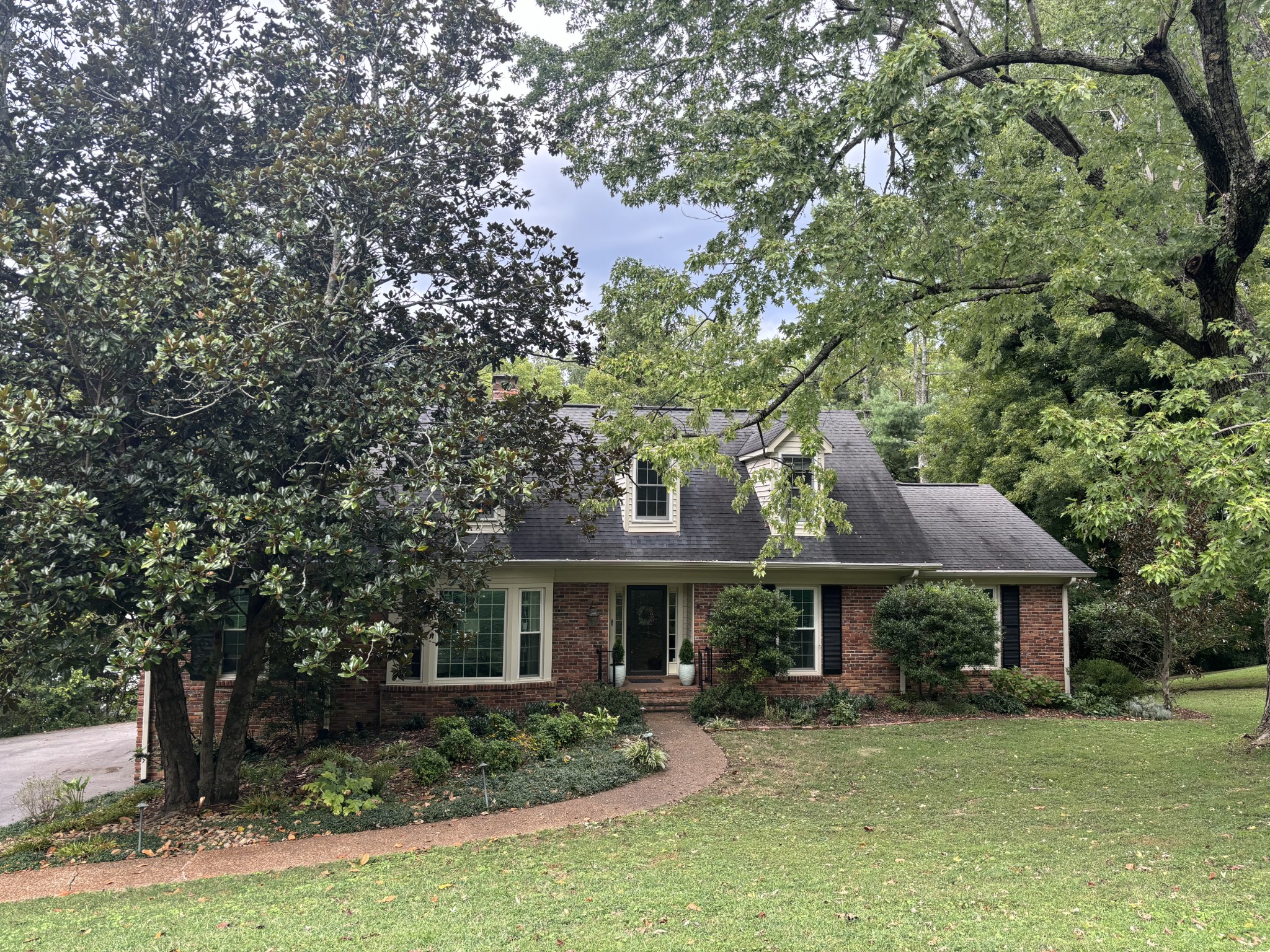 a front view of a house with garden