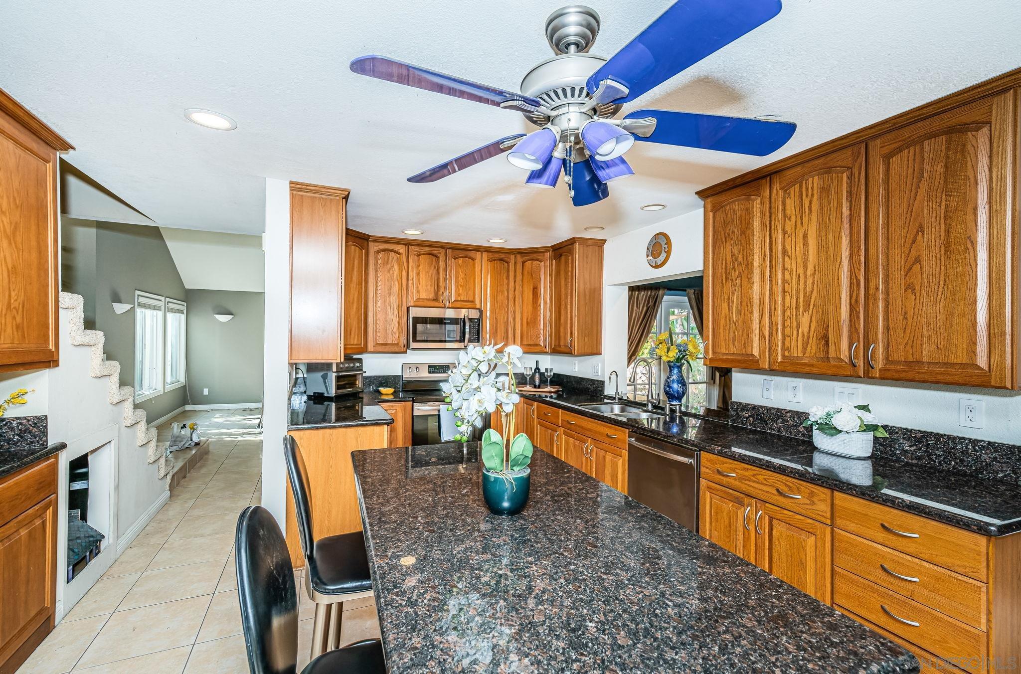 a large kitchen with a table and chairs