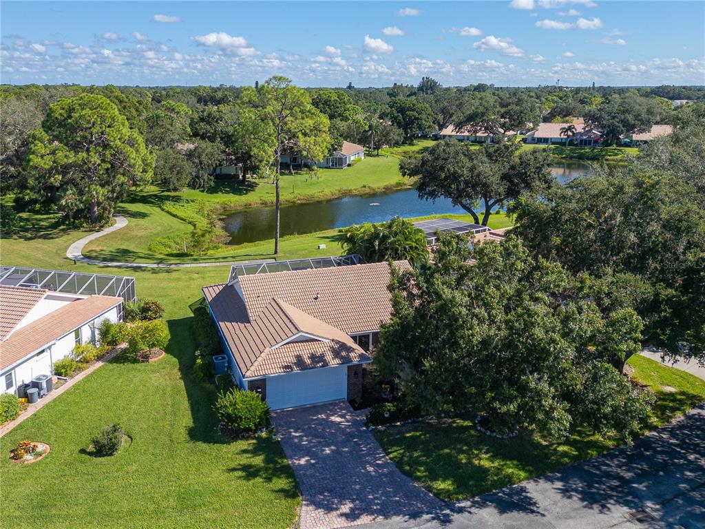 an aerial view of a house with a garden and swimming pool