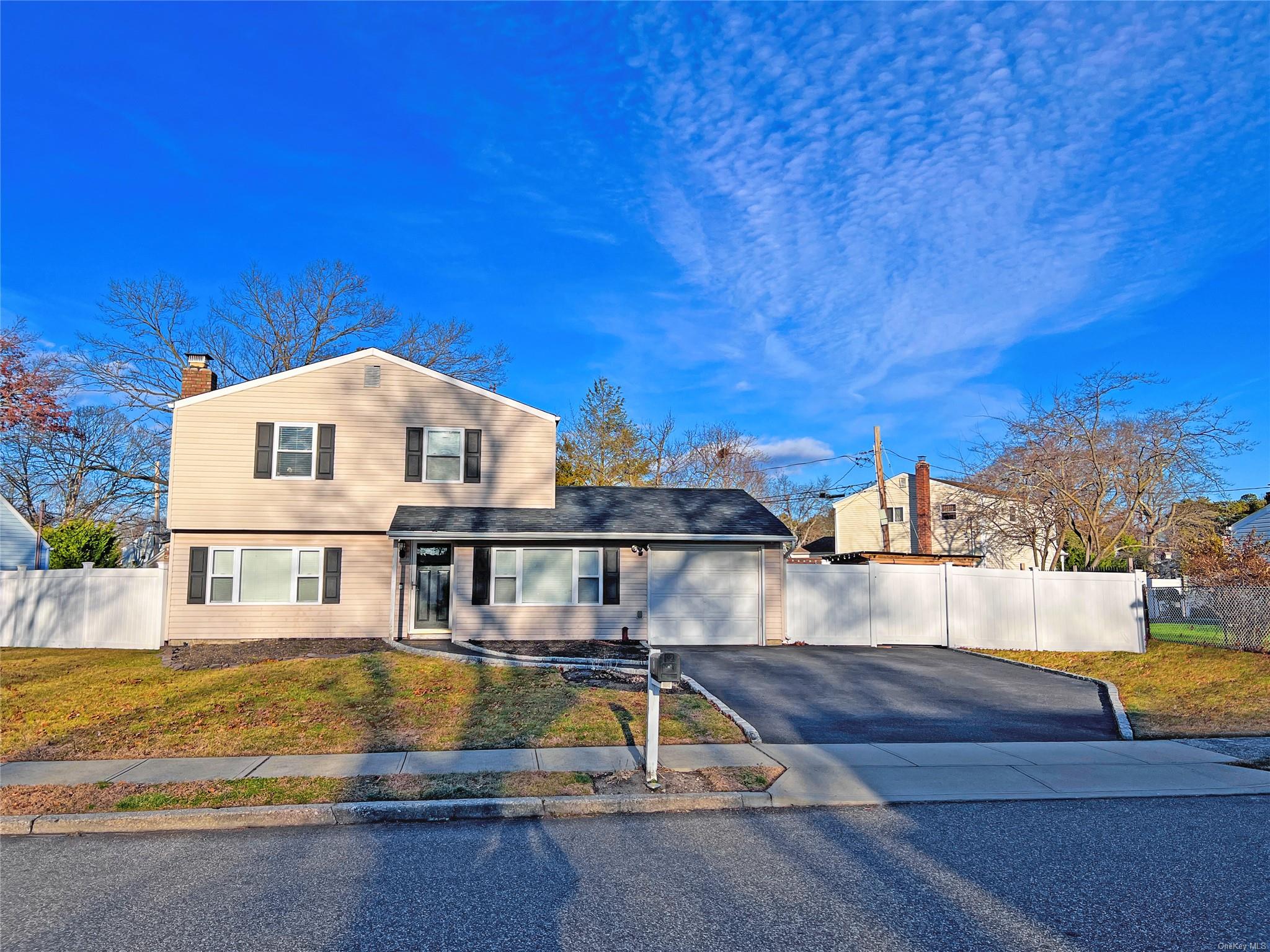 View of front of home featuring a garage and a front yard