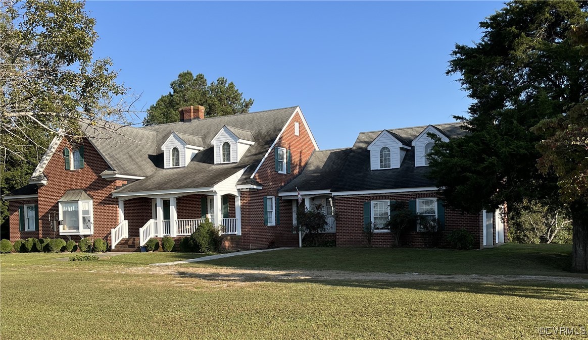 New england style home with covered porch and a fr