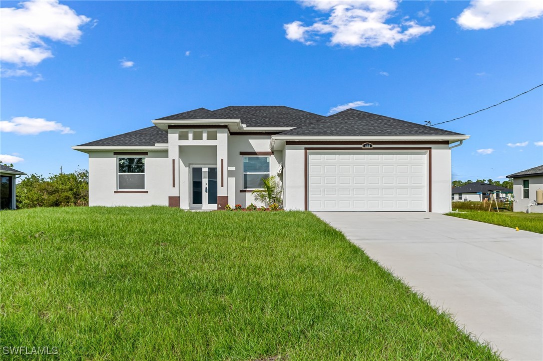 a front view of a house with a yard and garage