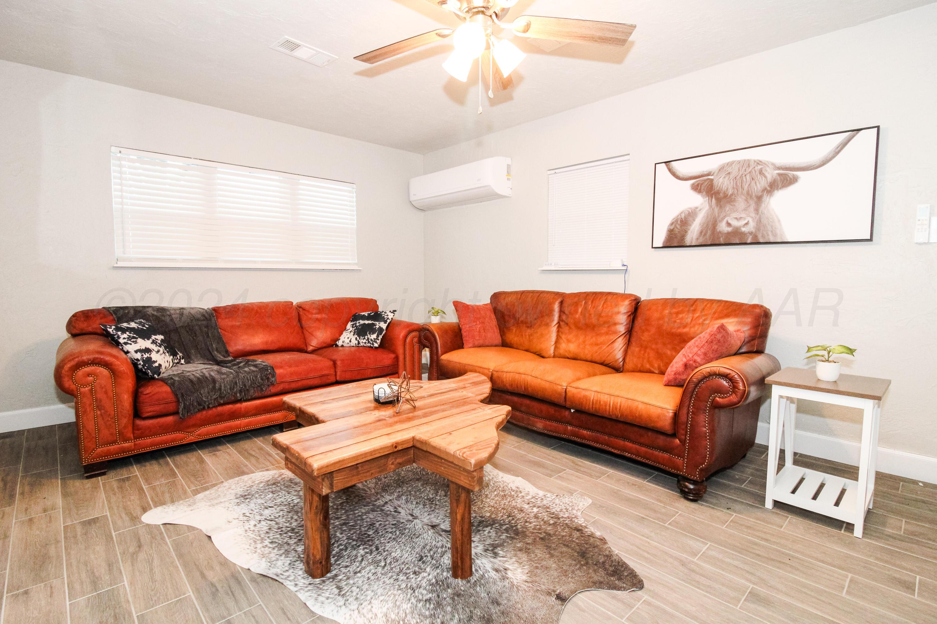 a blue living room with couches and a coffee table