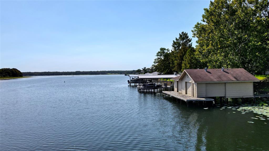 a view of a house with pool and lake view