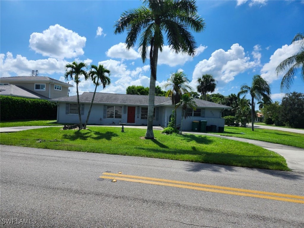 a front view of a house with a garden and a yard