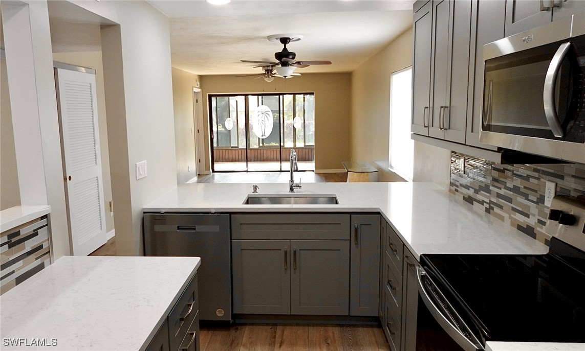 a kitchen with a sink stove and microwave