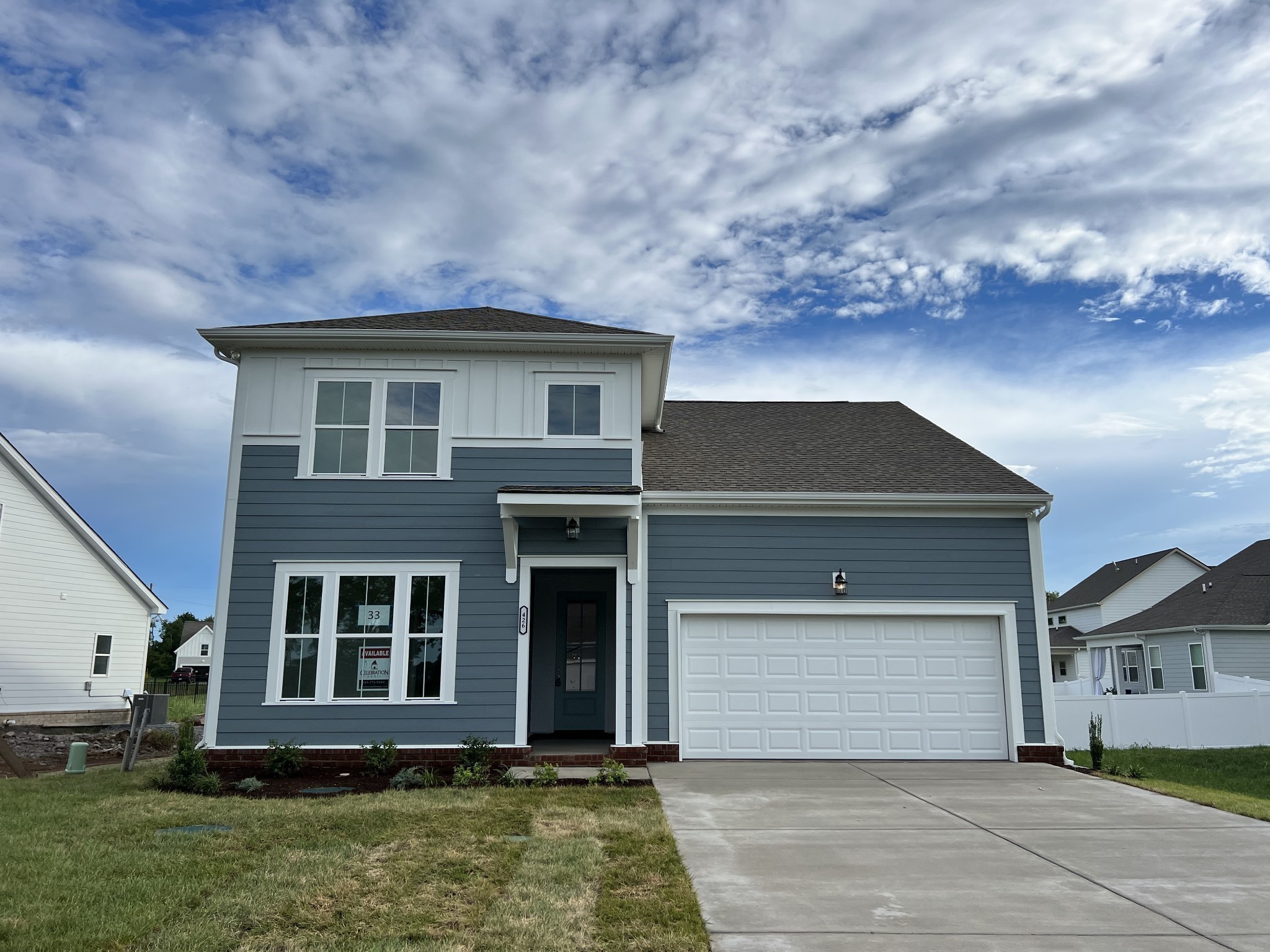 a front view of a house with a yard and garage