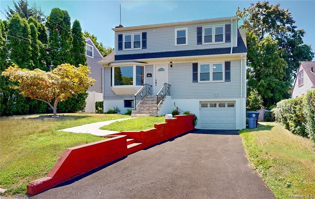 a front view of a house with swimming pool garden and patio