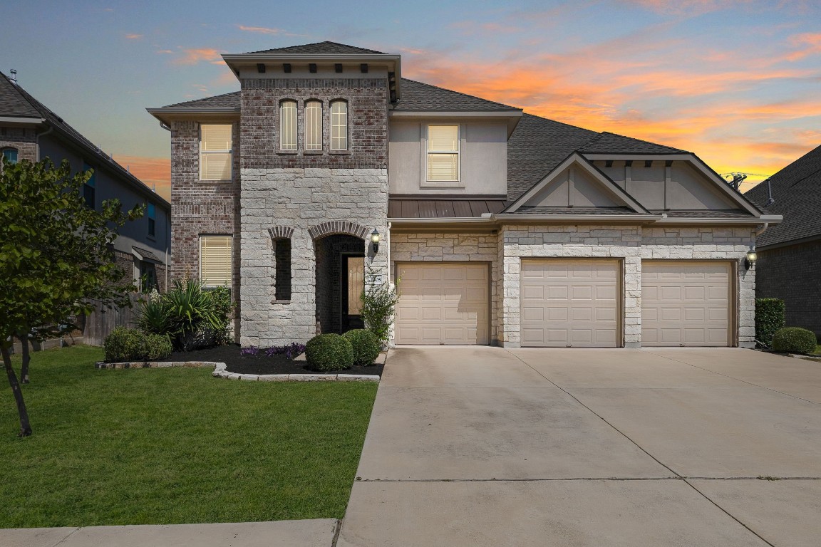 a front view of a house with a yard and garage