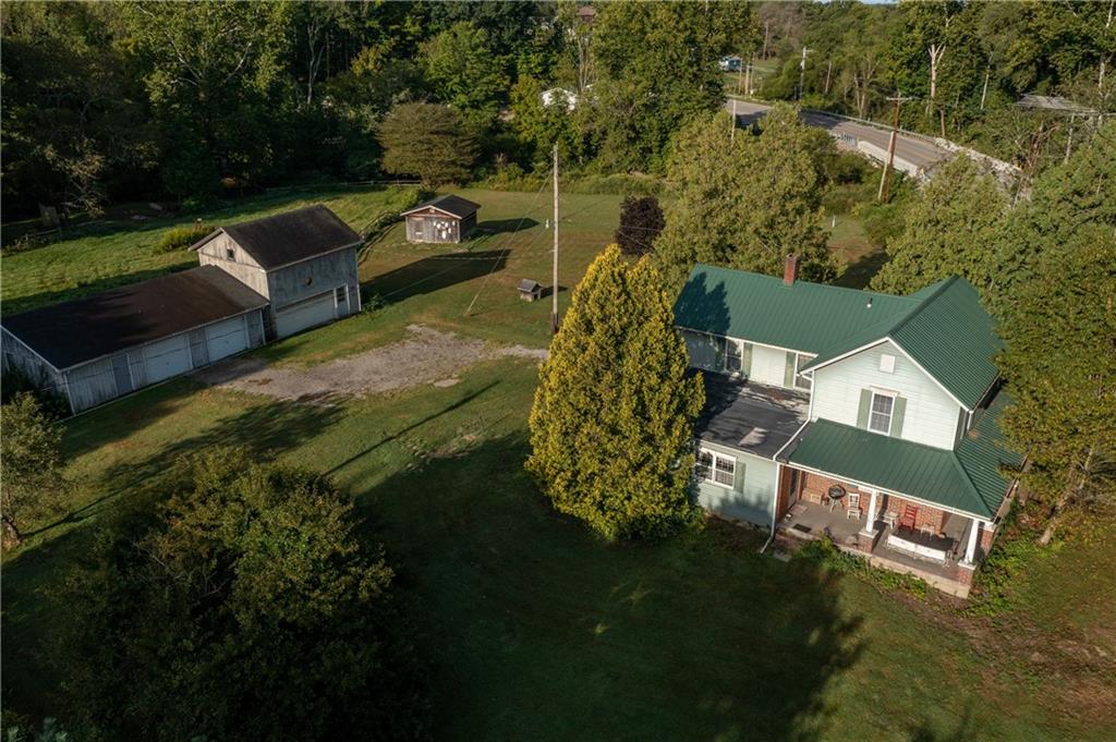 an aerial view of a house with a yard