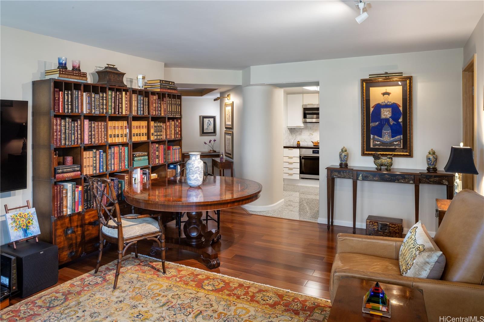 a living room with furniture a bookshelf and a bookshelf