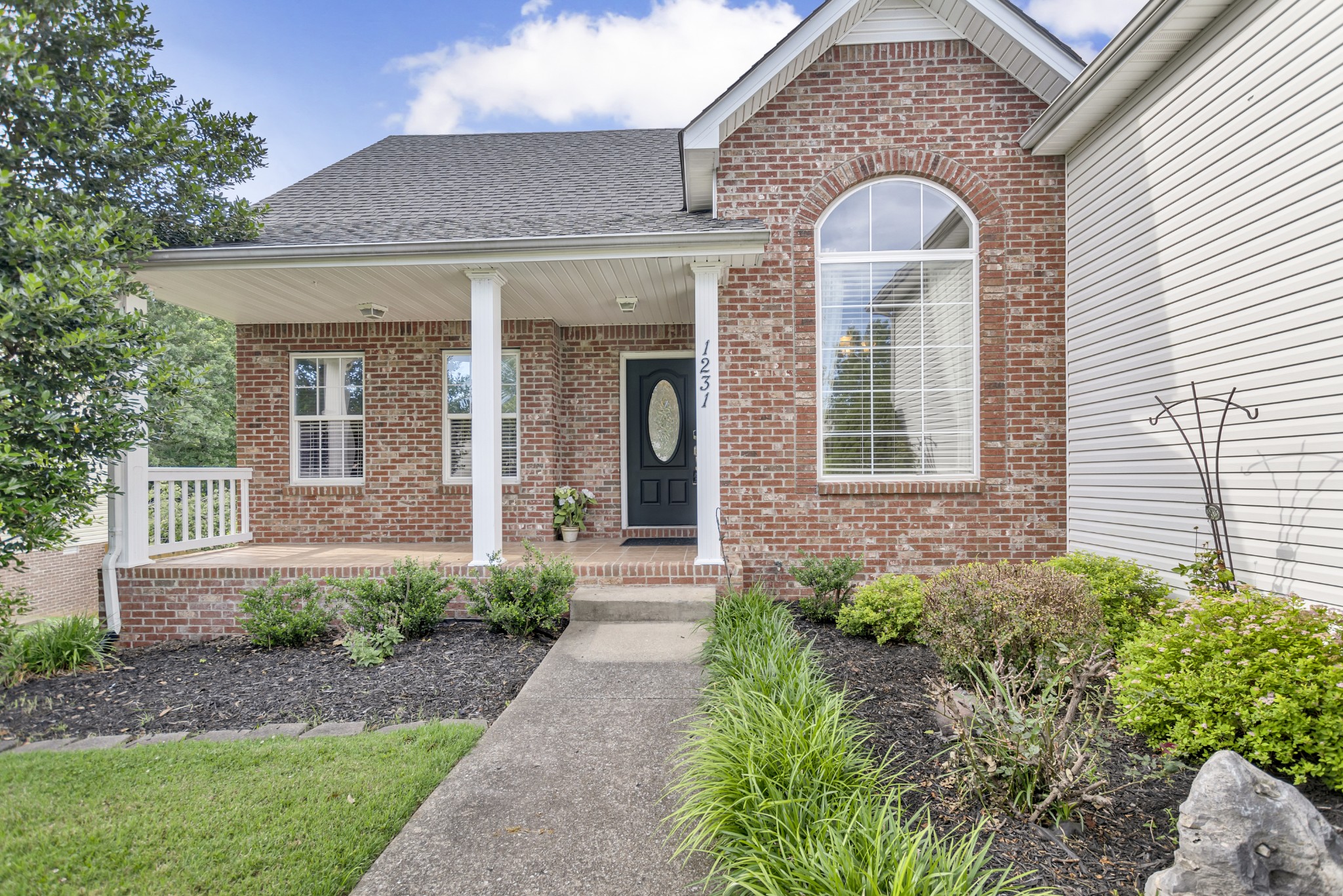 a front view of a house with garden