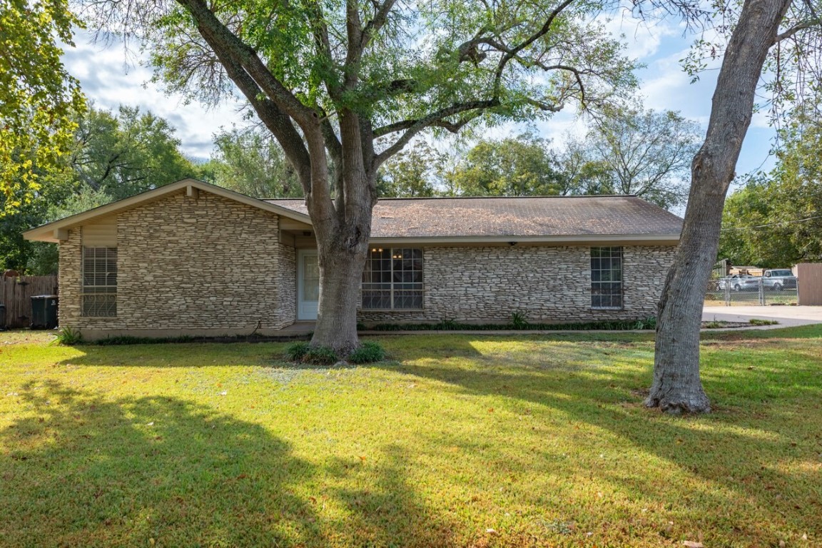 a view of a backyard with a tree