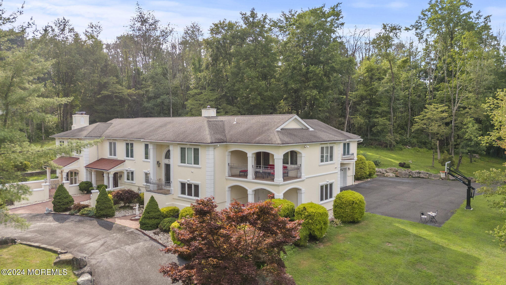 a aerial view of a house with a big yard plants and large trees