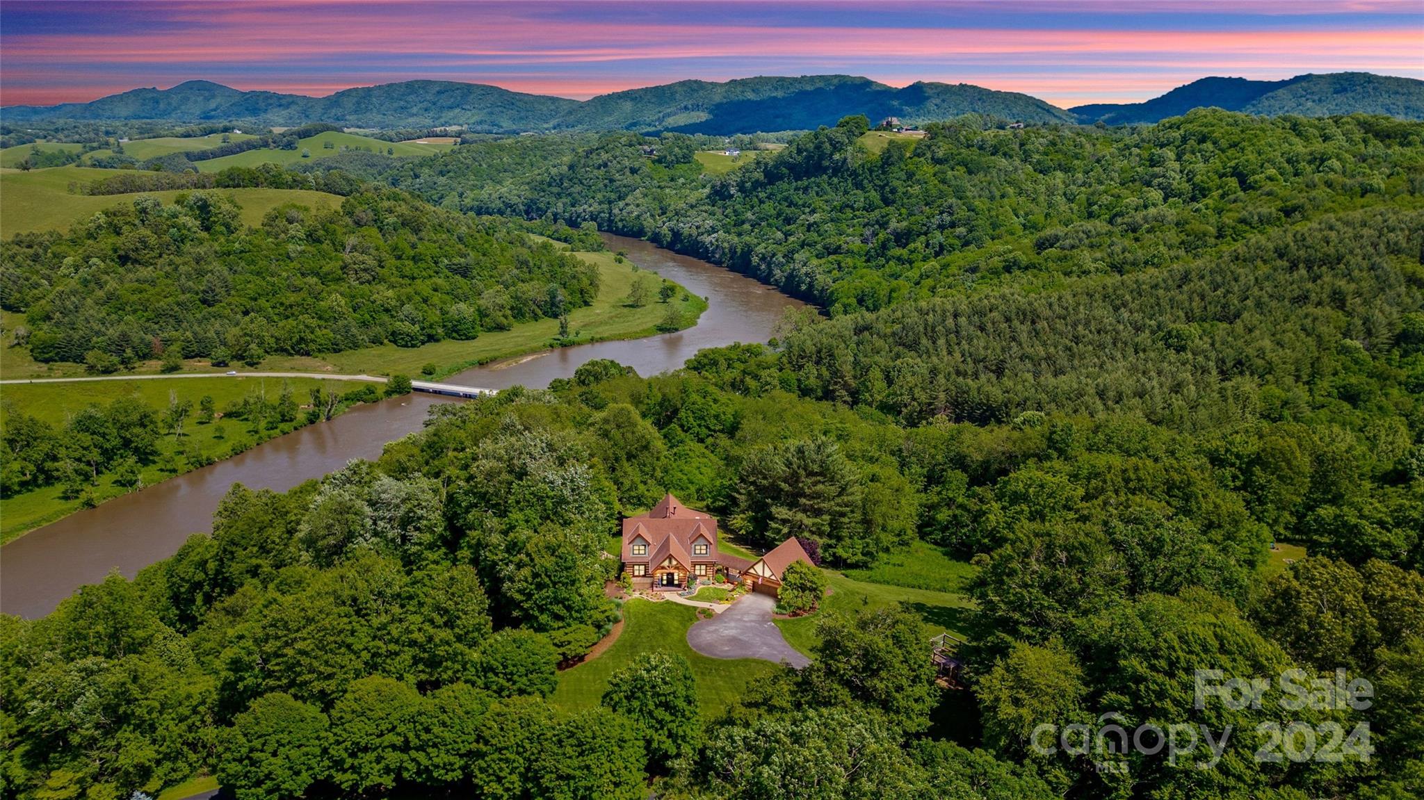 a view of a lush green hillside and a building in the background