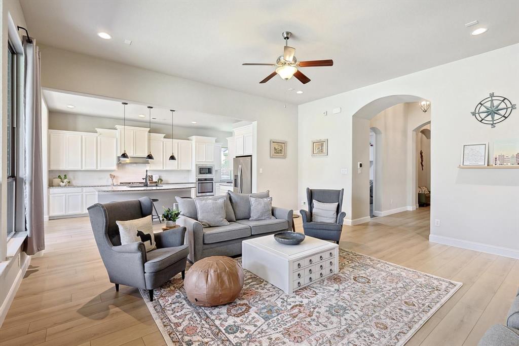 a living room with furniture and kitchen view