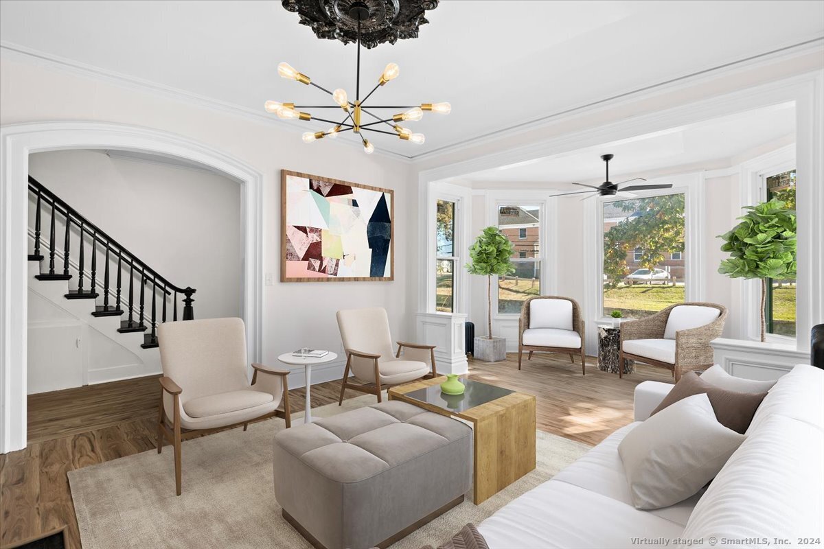 a living room with furniture ceiling fan and a rug