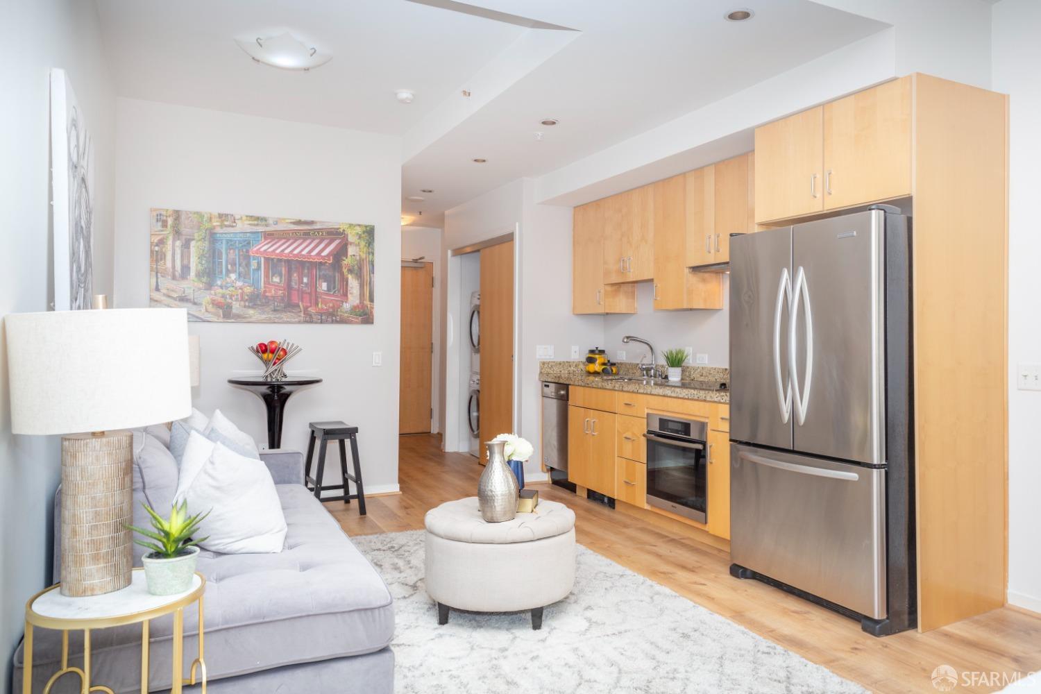 a living room with furniture and a refrigerator